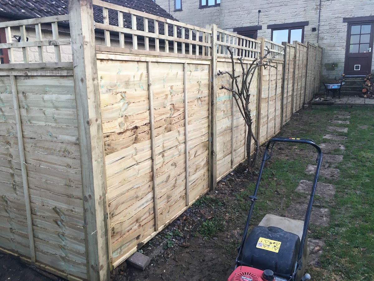 New timber fence panels being installed in a Dorset back garden